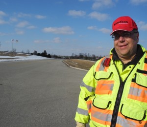 Bob Beilfuss standing by one of his department's completed road projects.