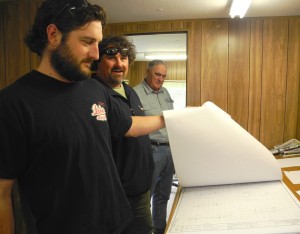 Jed Cook, Hannes Schneider & Roger Parks (l. to r.) checking the paper plans.