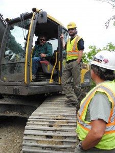 Consulting with Peter Reinhard, excavator operator.